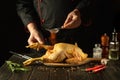 The chef prepares raw chicken in the kitchen. The cook adds paprika to rooster before frying. Preparing to fry fried chicken Royalty Free Stock Photo