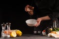 Chef prepares a salad dressing, pouring honey to cameralize shrimp. Freezing in motion, preparing healthy and wholesome food. On a