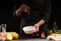 Chef prepares a salad dressing, pouring honey to cameralize shrimp. Freezing in motion, preparing healthy and wholesome food. On a