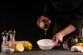 Chef prepares a salad dressing, pouring honey to cameralize shrimp. Freezing in motion, preparing healthy and wholesome food. On a