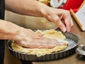 Chef prepares shortcrust cake and puts the dough into mold Royalty Free Stock Photo