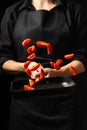 The chef prepares tomato sauce, fries tomatoes, cherry tomatoes in a frying pan, freezes, pasta, pizza. process steps in the