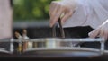 The chef prepares walleye fillets on the terrace of the summer restaurant. Show kitchen for restaurant guests.