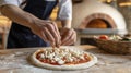 Chef preparing artisan pizza with fresh ingredients in rustic kitchen setting Royalty Free Stock Photo