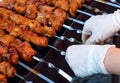 The chef is preparing a barbecue in gloves. We cook meat on the grill outdoors. BBQ