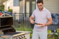 Chef preparing barbecue. Male cook cooking meat on barbecue grill. Man cooking salmon fillet on barbecue for summer Royalty Free Stock Photo