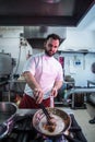 Chef preparing beef fillet steak in a frying pan