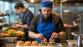 Chef Preparing Burgers in a Busy Restaurant Kitchen Royalty Free Stock Photo