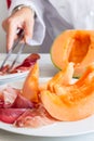 Chef preparing dish with melon and ham Royalty Free Stock Photo