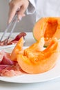Chef preparing dish with melon and ham Royalty Free Stock Photo