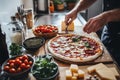 Chef preparing fresh homemade pizza with cheese and basil in rustic kitchen setting Royalty Free Stock Photo