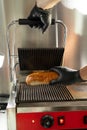 Chef preparing hot dogs in an electric grill,close-up Royalty Free Stock Photo