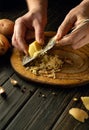 Chef is preparing potato pancakes on the kitchen table. Close-up of a cook hands grating potatoes Royalty Free Stock Photo