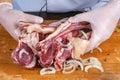 Chef preparing raw lamb chops for cooking separating the rack of lamb Royalty Free Stock Photo