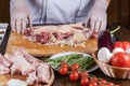 Chef preparing raw lamb chops for cooking separating the rack of lamb