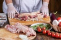Chef preparing raw lamb chops for cooking separating the rack of lamb Royalty Free Stock Photo