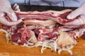 Chef preparing raw lamb chops for cooking separating the rack of lamb Royalty Free Stock Photo