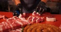Chef preparing the raw lamb loin chops for barbecue making a queue. Royalty Free Stock Photo