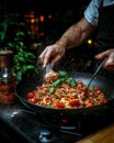 Chef preparing spaghetti with basil and tomatoes. Royalty Free Stock Photo