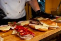 Chef preparing subway sandwich, live cooking session. Fast food festival, street food