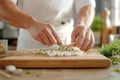 Chef preparing sushi rolls with salmon and herbs on a wooden board Royalty Free Stock Photo