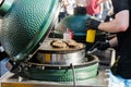 Chef preparing tasty burgers at outdoor stand. Royalty Free Stock Photo