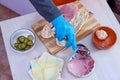 Chef preparing tasty sub sandwich from fresh ingredients. Royalty Free Stock Photo