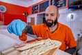 Chef preparing tasty sub sandwich from fresh ingredients.