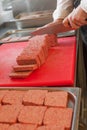 Chef preparing traditional Scottish square or lorne sausage