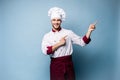 Chef presenting something over light blue background Royalty Free Stock Photo