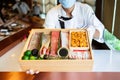 The chef presents the premium fresh ingredients in a wooden box before making the omakase meal.