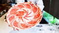 The chef presents Premium Rare Slices Kagoshima Wagyu A5 beef with a high-marbled texture on a circle plate served for Omakase Royalty Free Stock Photo