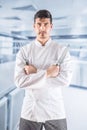 Chef professional in restaurant kitchen standing with crossed hands and holding fork and knife Royalty Free Stock Photo