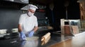 Chef  with protective coronavirus face mask preparing pizza Royalty Free Stock Photo