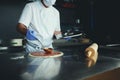 Chef  with protective coronavirus face mask preparing pizza Royalty Free Stock Photo