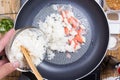 Chef put cooking rice to pan Royalty Free Stock Photo