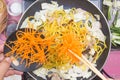 Chef put slice of carrot for cooking Yakisoba noodle Royalty Free Stock Photo