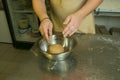 The process of making bread. The chef puts the kneaded dough into a bowl