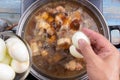 Chef putting boiled eggs for cooking Royalty Free Stock Photo