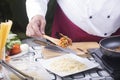 Chef putting chicken sauce to spaghetti on the plate Royalty Free Stock Photo