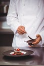 Chef putting chocolate sauce on a dessert Royalty Free Stock Photo