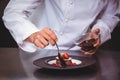 Chef putting chocolate sauce on a dessert Royalty Free Stock Photo