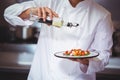 Chef putting finishing touch on salad Royalty Free Stock Photo