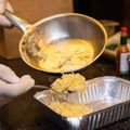 Chef putting fried onion to the box Royalty Free Stock Photo