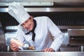 Chef putting sauce on a dish of spaghetti Royalty Free Stock Photo