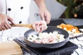 Chef putting slice pf pork to the pan for cooking Japanes pork c