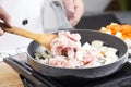 Chef putting slice pf pork to the pan for cooking Japanese pork Royalty Free Stock Photo