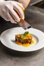 Chef rasping orange zest Royalty Free Stock Photo