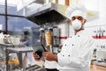 Chef in respirator with tablet pc at kebab shop Royalty Free Stock Photo