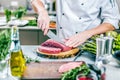 Chef cutting and cooking meat in the restaurant kitchen Royalty Free Stock Photo